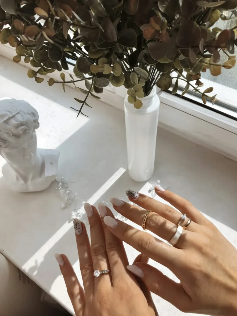 Hands with rings by a plaster bust in window light