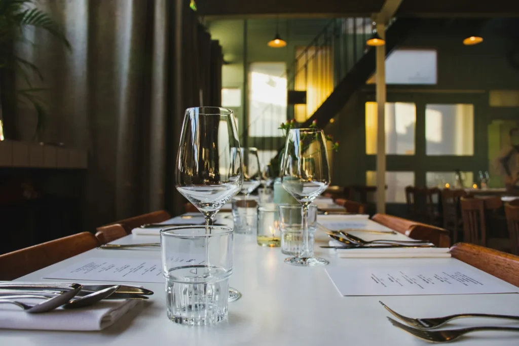 Table set with white linen and wine glasses