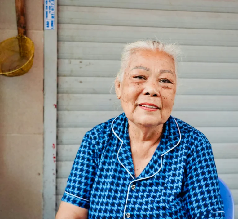 Owner smiling in a blue blouse