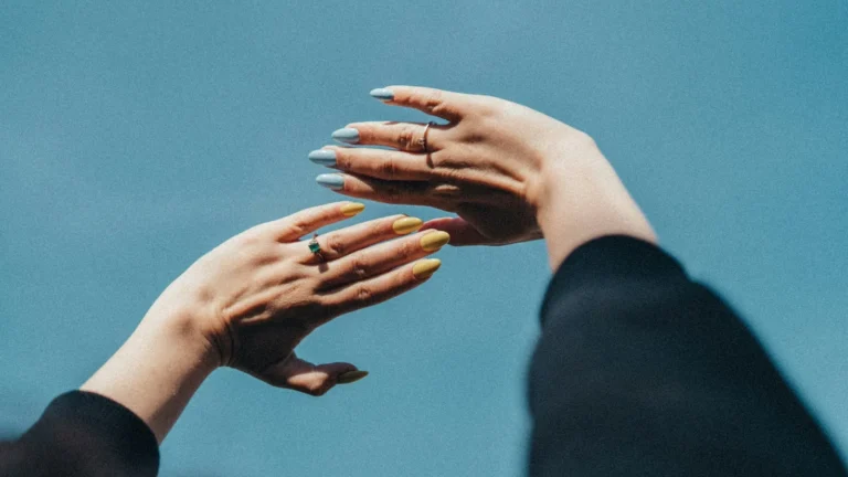 Hands against a blue sky