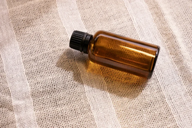 Amber serum bottle on linen