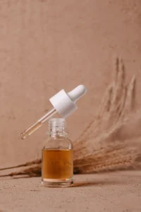 Serum dropper on a clay-colored backdrop