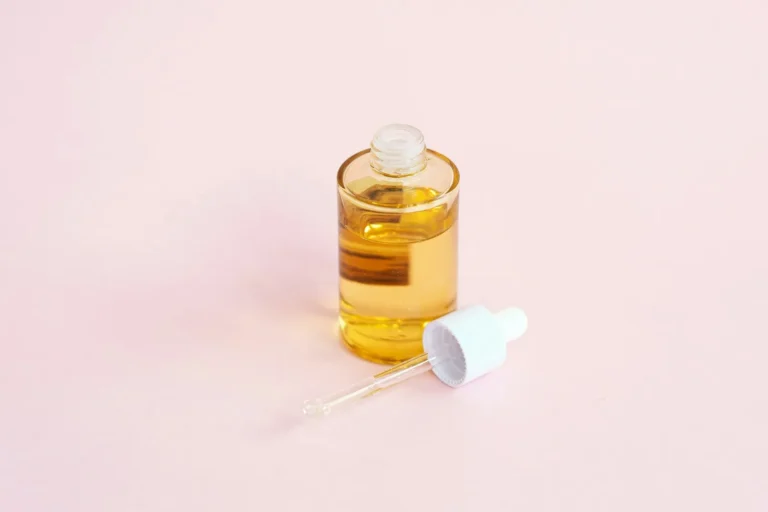 Face oil bottle on pink