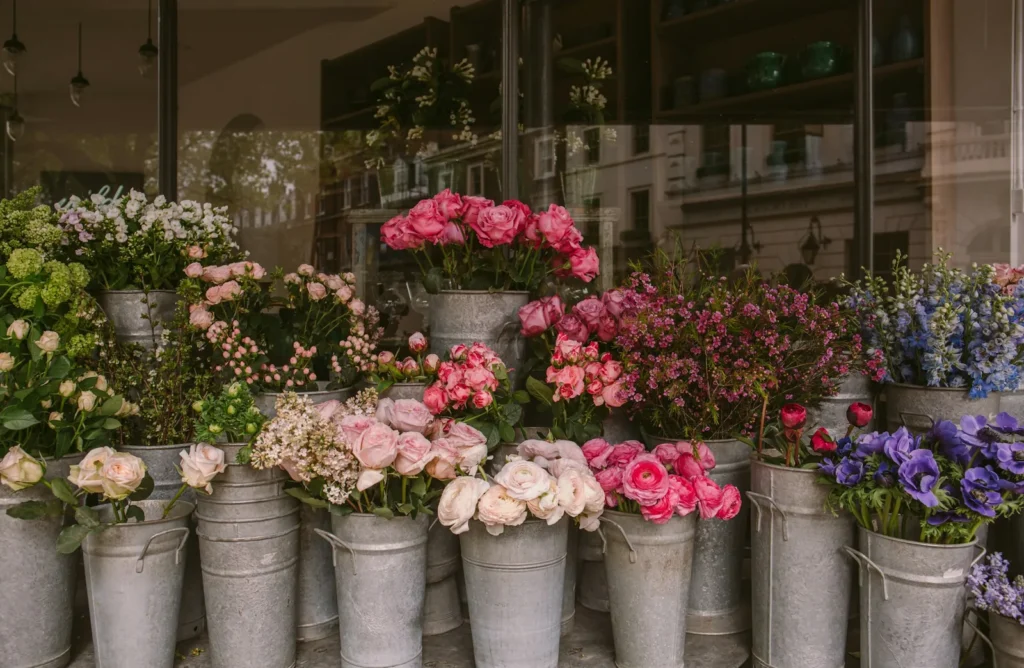 Buckets of fresh flowers in the window