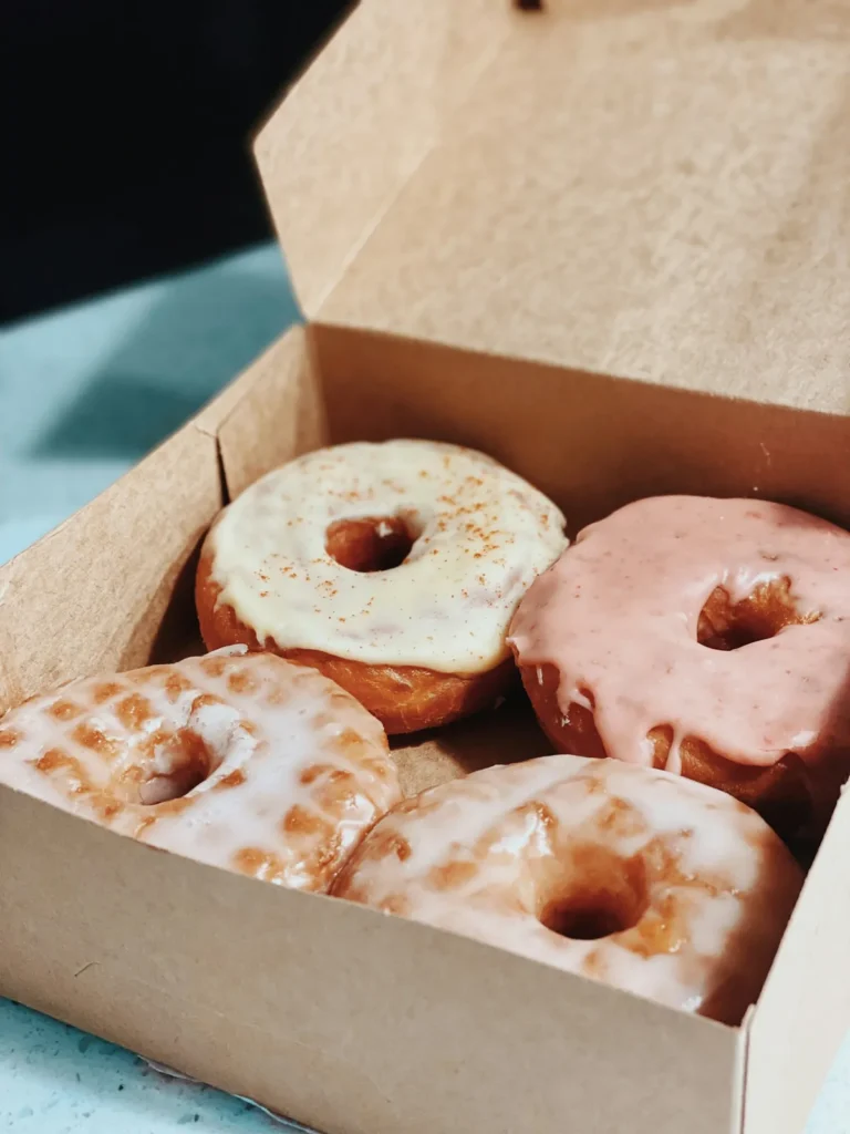 Box of glazed and strawberry donuts