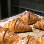Croissants cooling on a baking tray