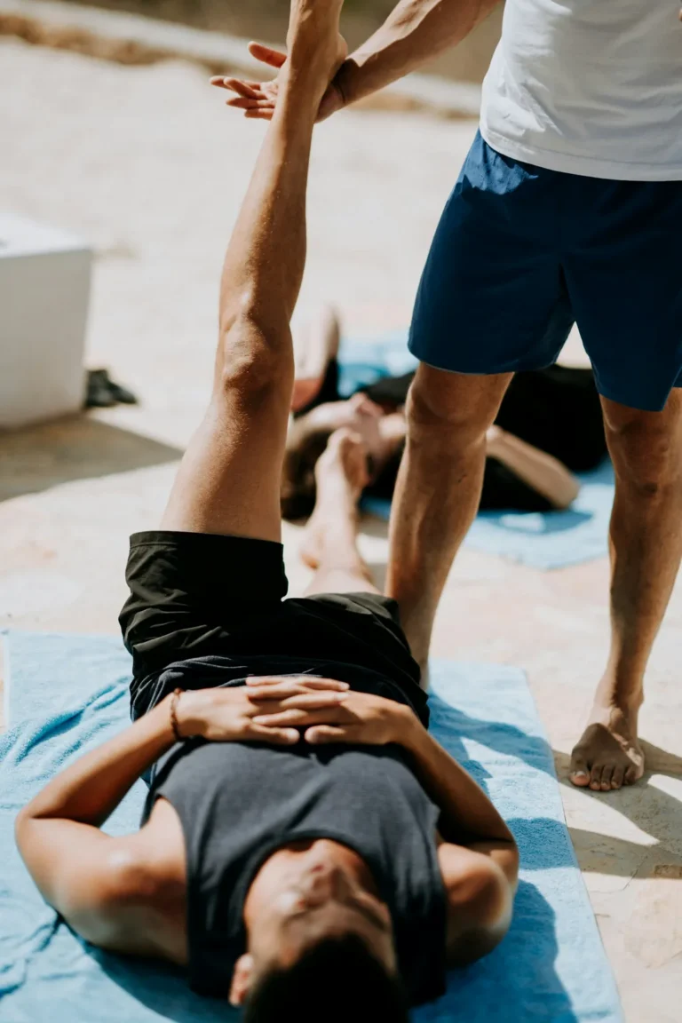 Assisted hamstring stretch on a mat