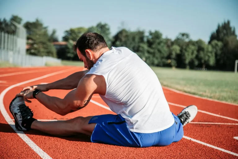 Runner stretching on the track