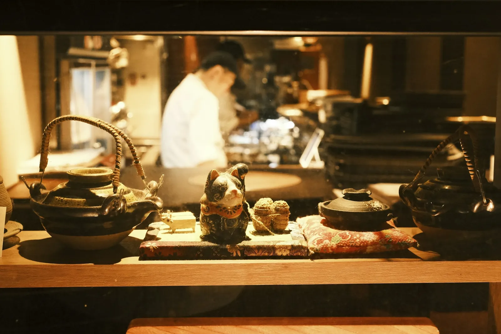 Kitchen with cast-iron teapots in warm light