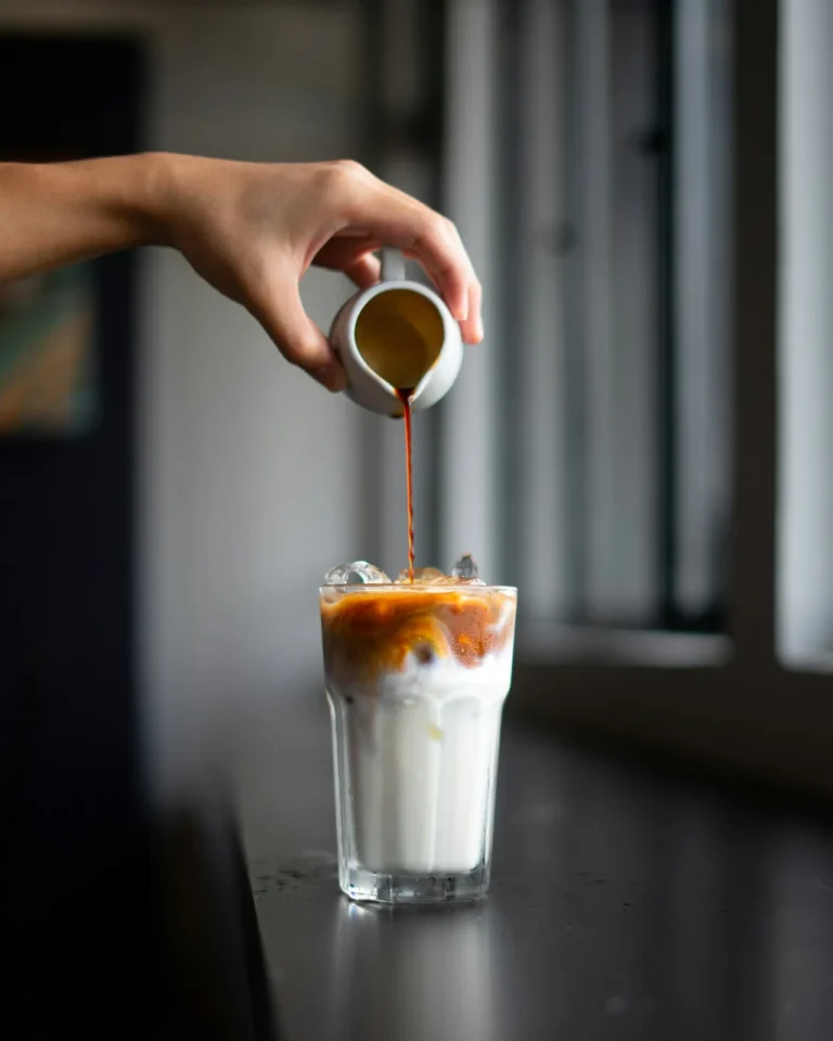 Coffee poured over milk and ice