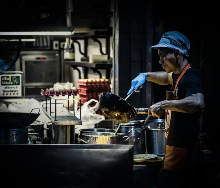 Cook at the grill with blue gloves