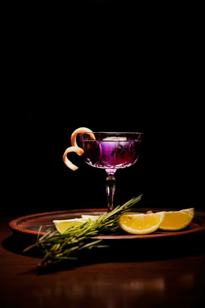 Violet martini with a lemon twist