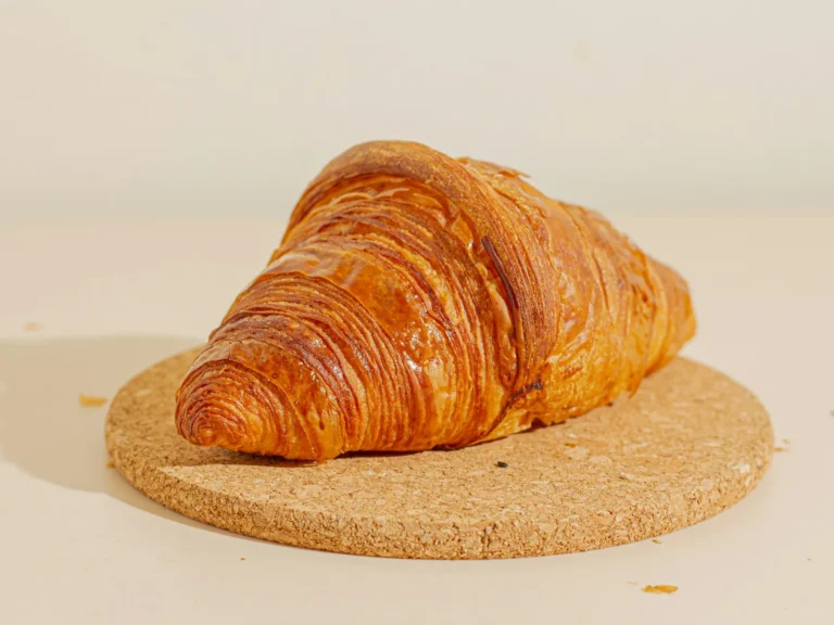 Butter croissant on a cork board