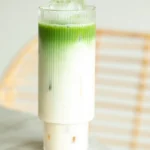 Iced matcha latte in a tall ribbed glass