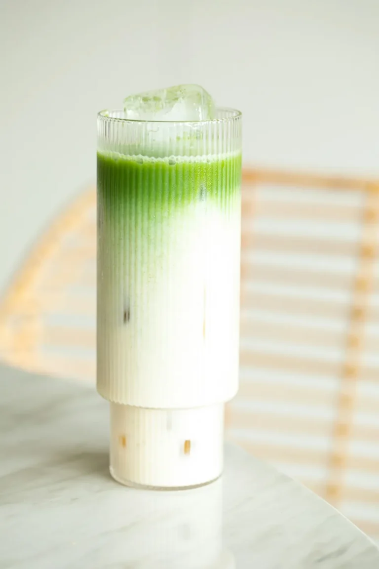 Iced matcha latte in a tall ribbed glass