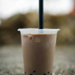 Taro milk tea with a black straw