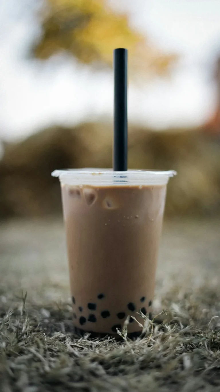 Taro milk tea with a black straw