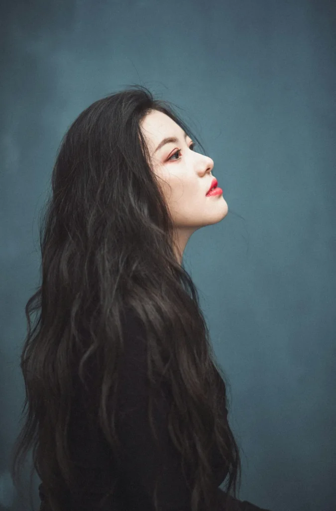 Woman with long dark hair in profile