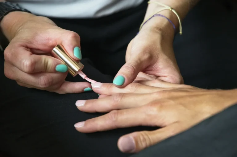 Teal gel polish being painted