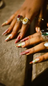 Long almond nails in red and white with rings