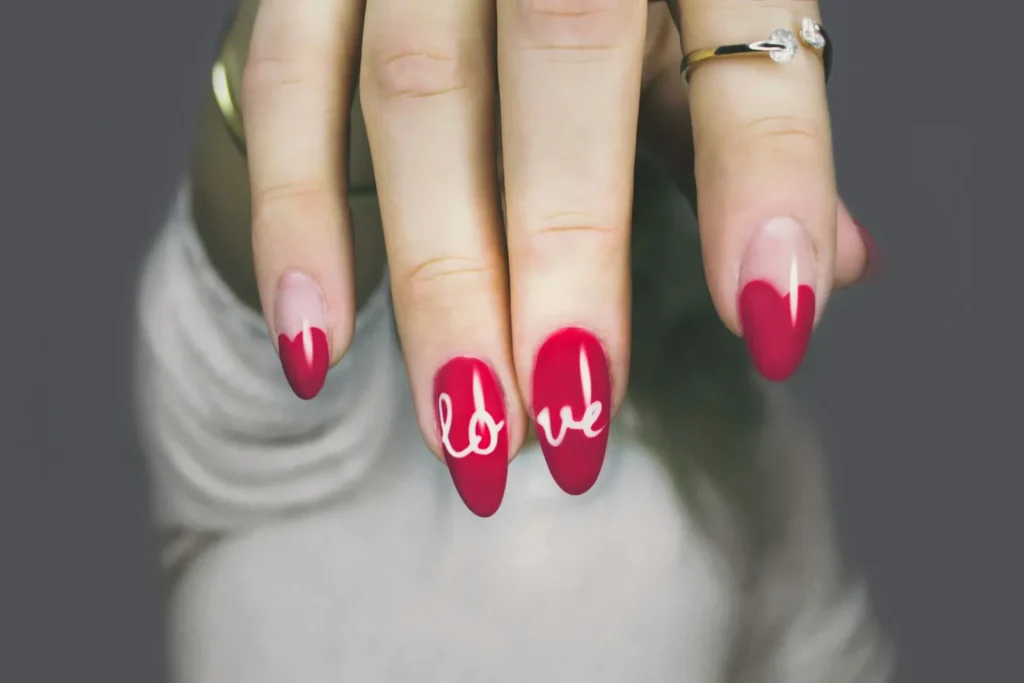 Red nails with hand-lettered love art