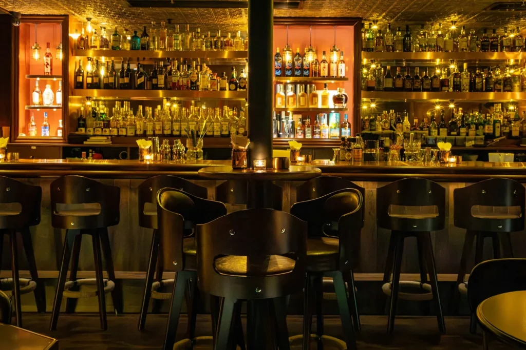 Long bar with a lit back bar of bottles
