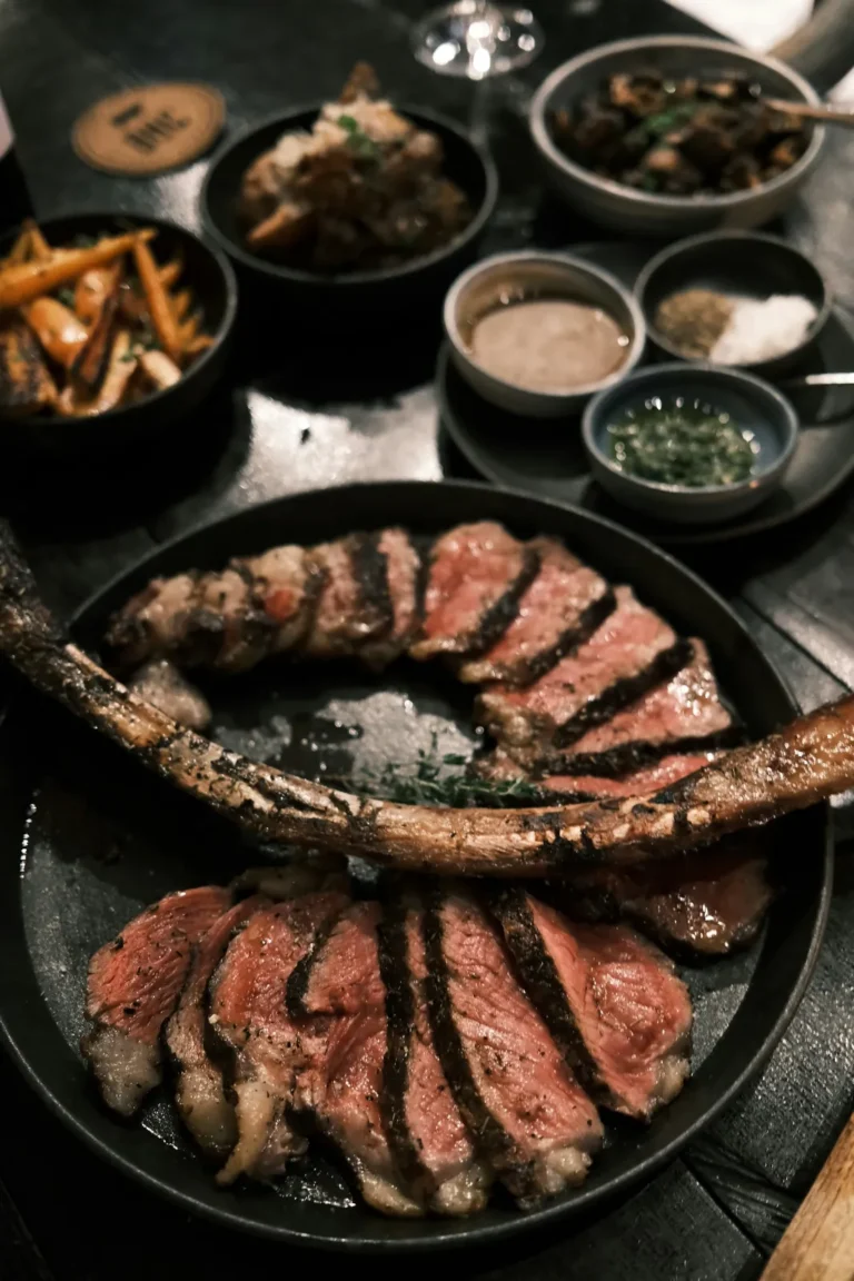 Sliced tomahawk in a cast-iron pan with sides