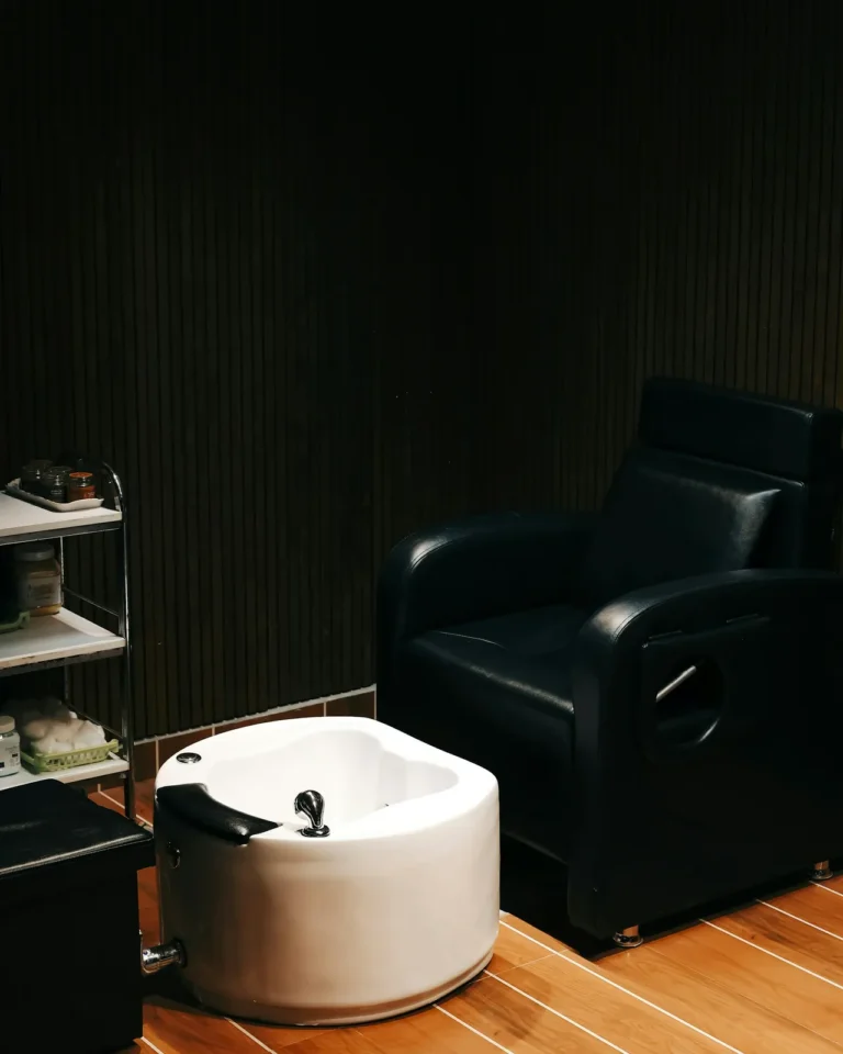 Black leather pedicure chair and white basin