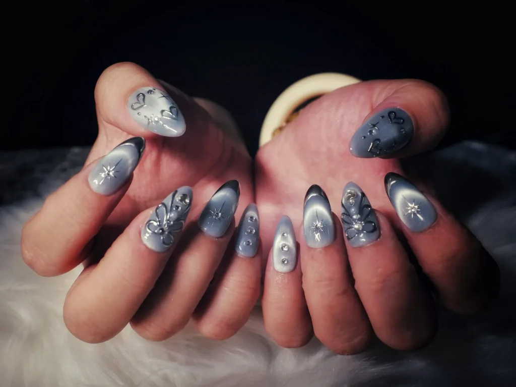 Silver chrome stiletto nails on dark fur
