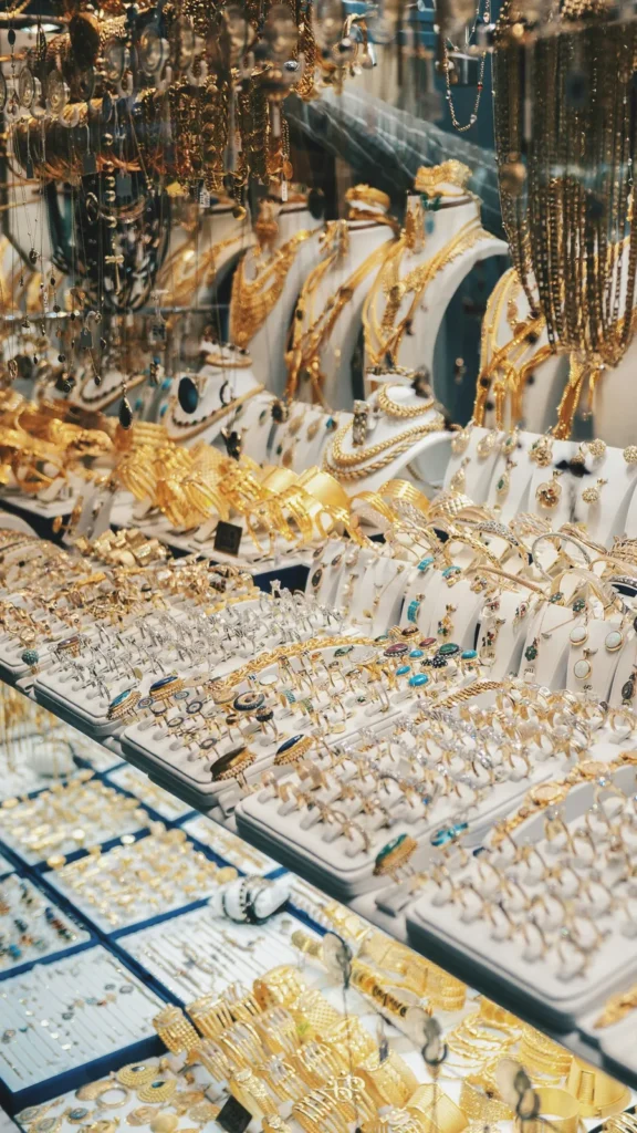 A glass case full of gold jewelry