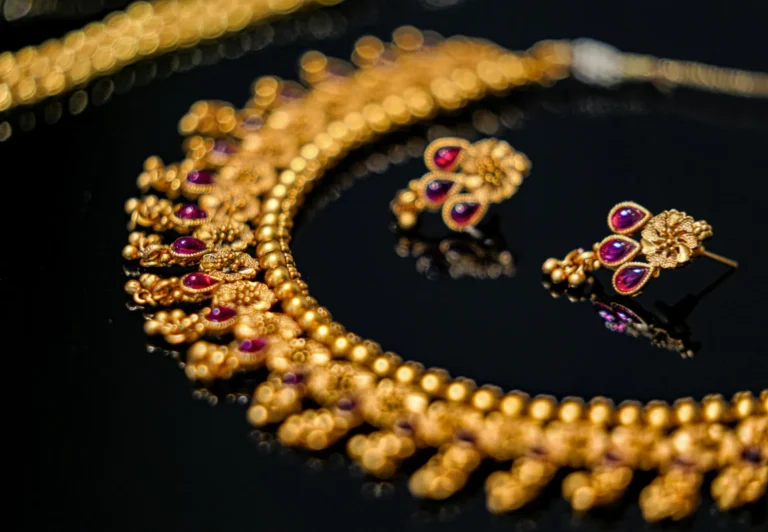 Gold necklace and earring set with red stones