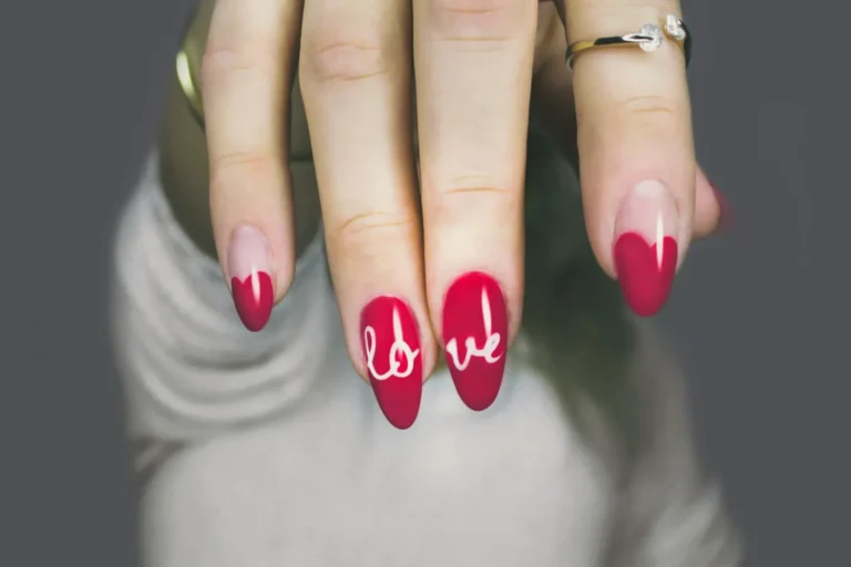 Red nails with the word love painted on