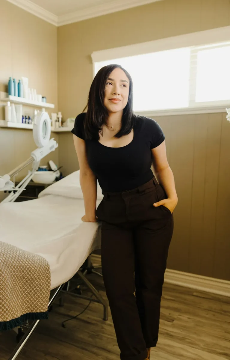 Esthetician by the facial bed