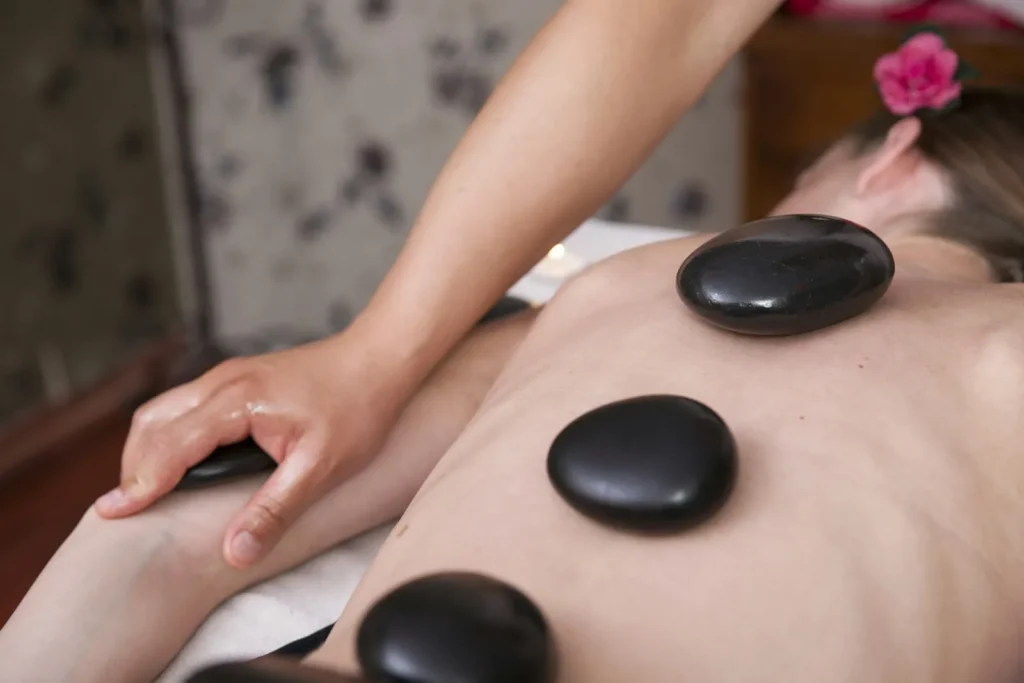 Hot stones on the back and a pink flower