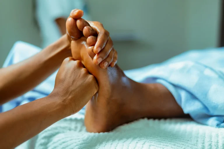 Foot reflexology on a heated table