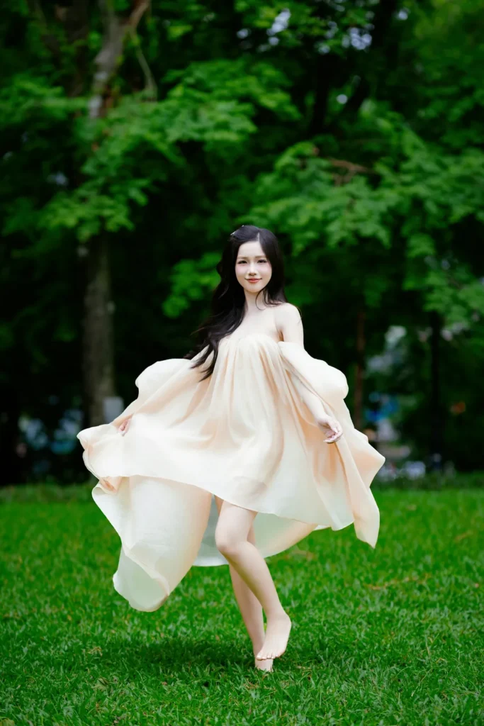 Woman in a cream dress mid-turn