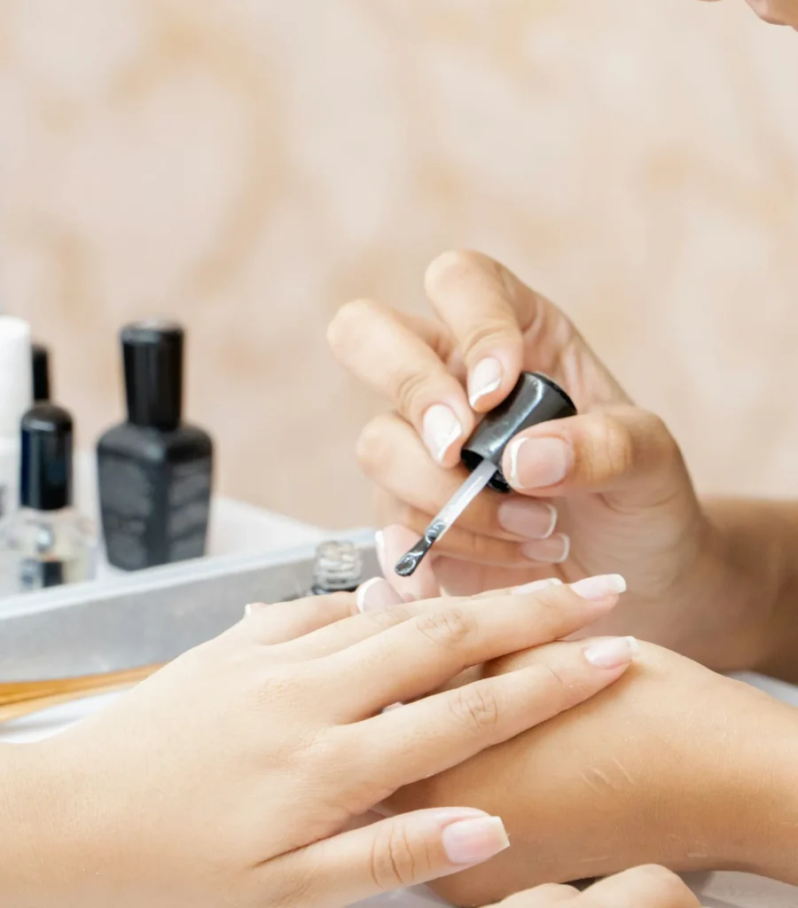 Nail technician serving a client